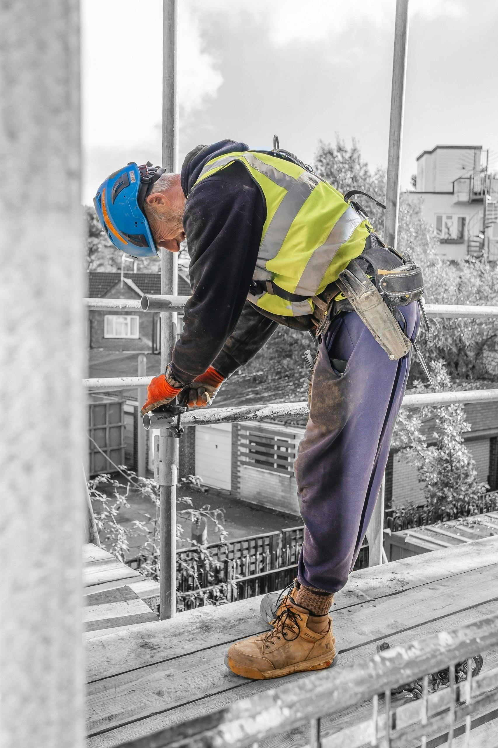 Man working on scaffolding scaffolder wearing a hard hat
